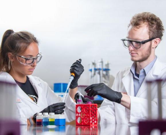 two chemistry students in a lab